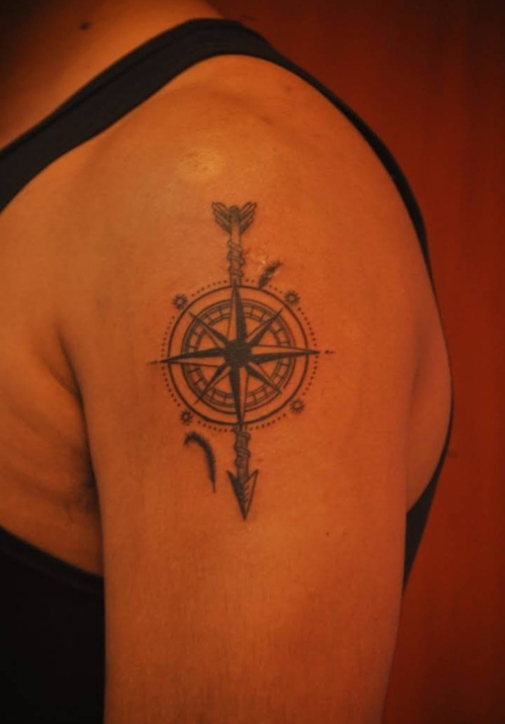 Compass rose and arrow shoulder tattoo by DMR Tattoo Studio Diu
